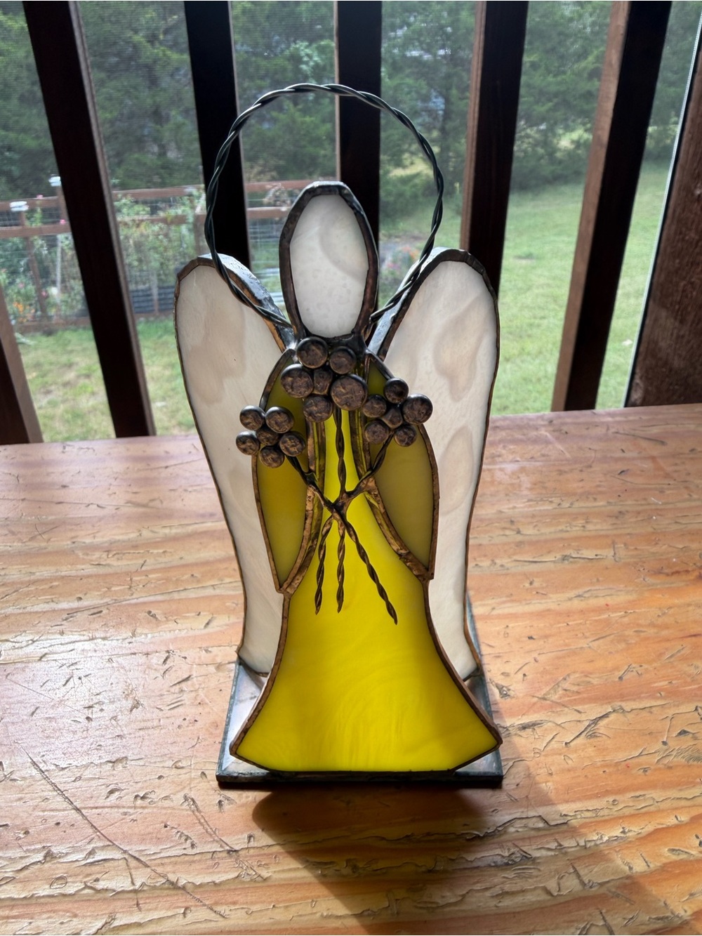 Vintage stain glass angel holding flowers